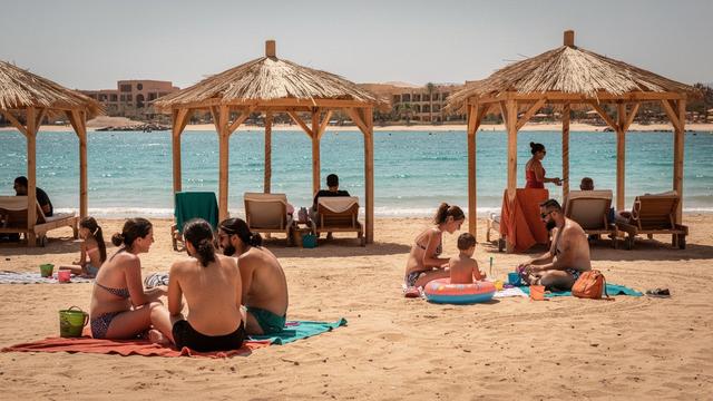 Family beach huts and turquoise water at a resort in Sharm El Sheikh, Egypt